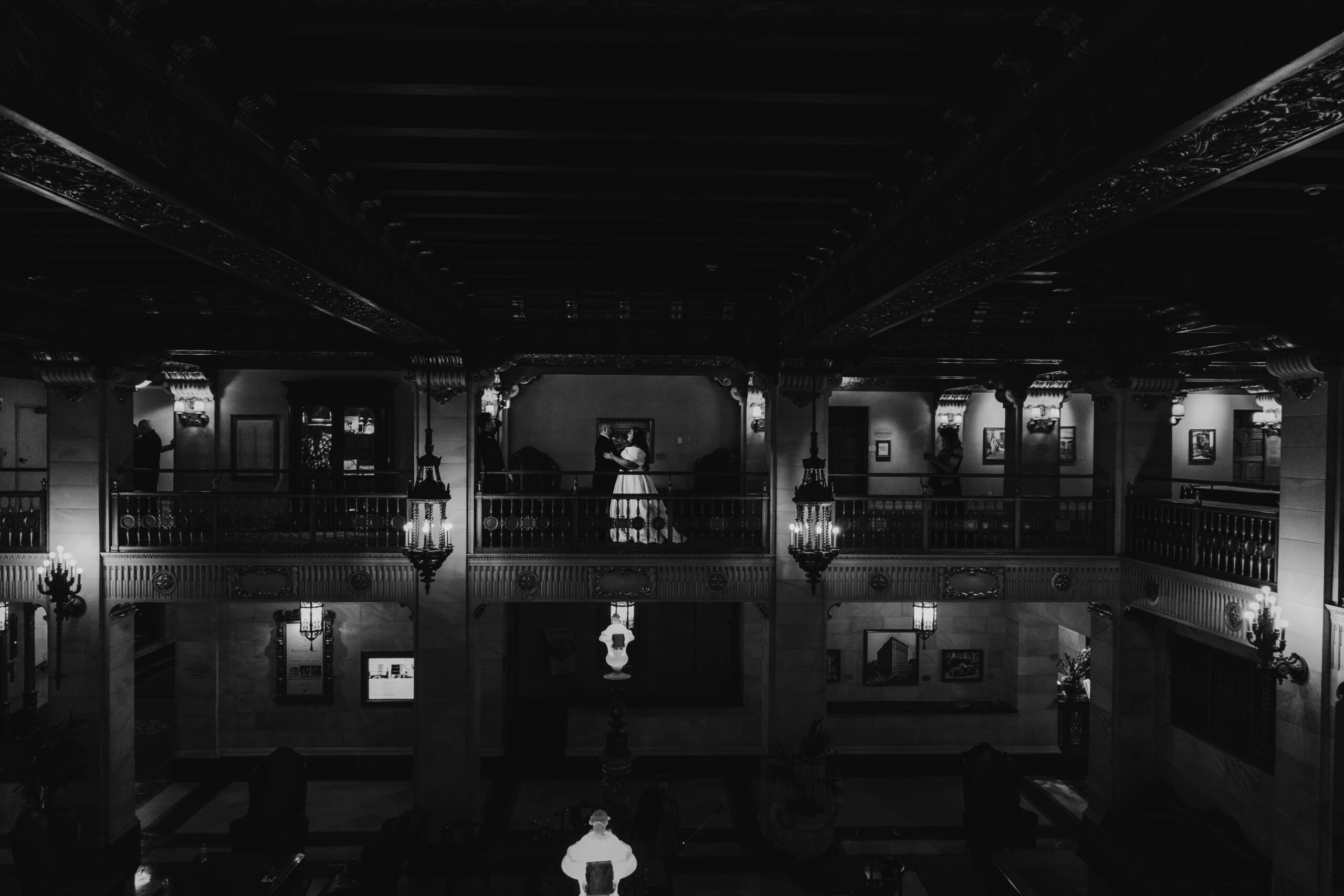 a bride and groom facing one another on the balcony of the historic davenport in spokane washington