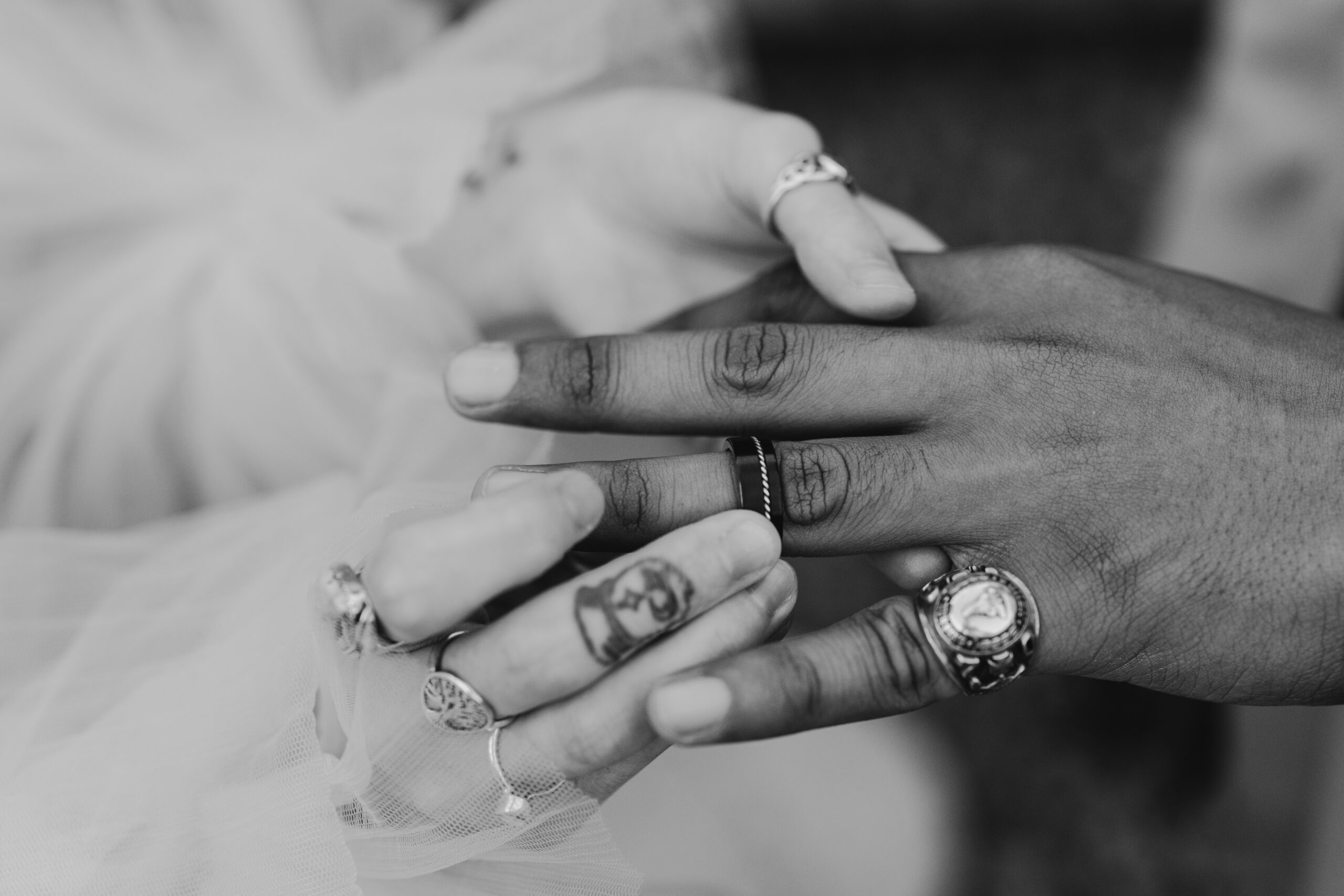 a bride placing the ring on the grooms finger