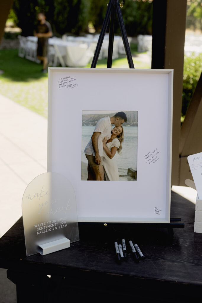 a framed photo of the couple for guests to sign 