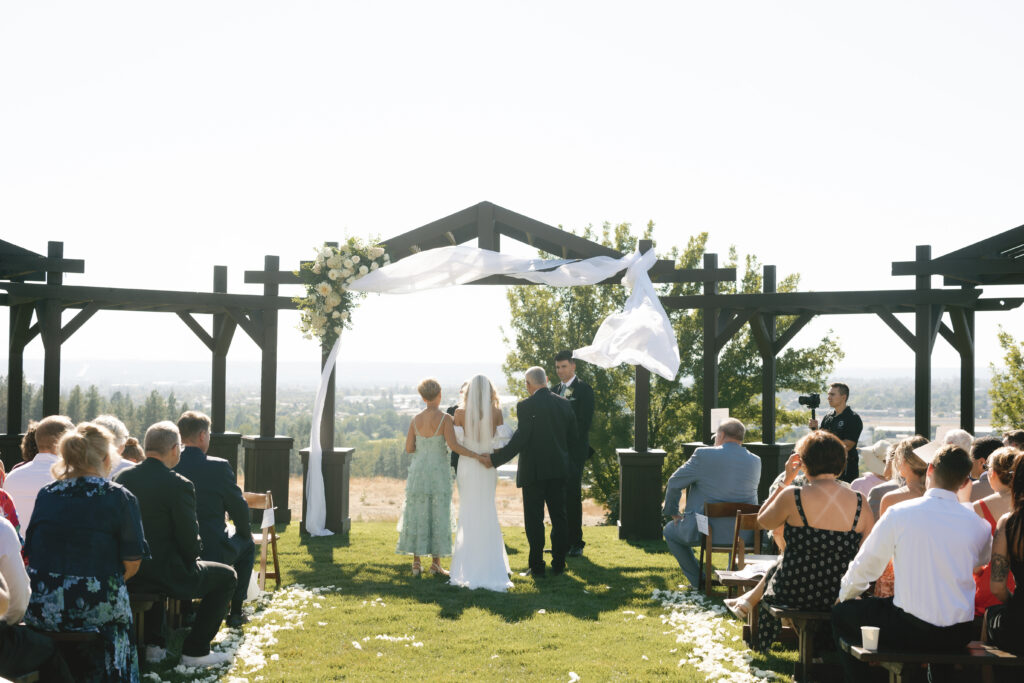 a bride and her parents walking her down the aisle