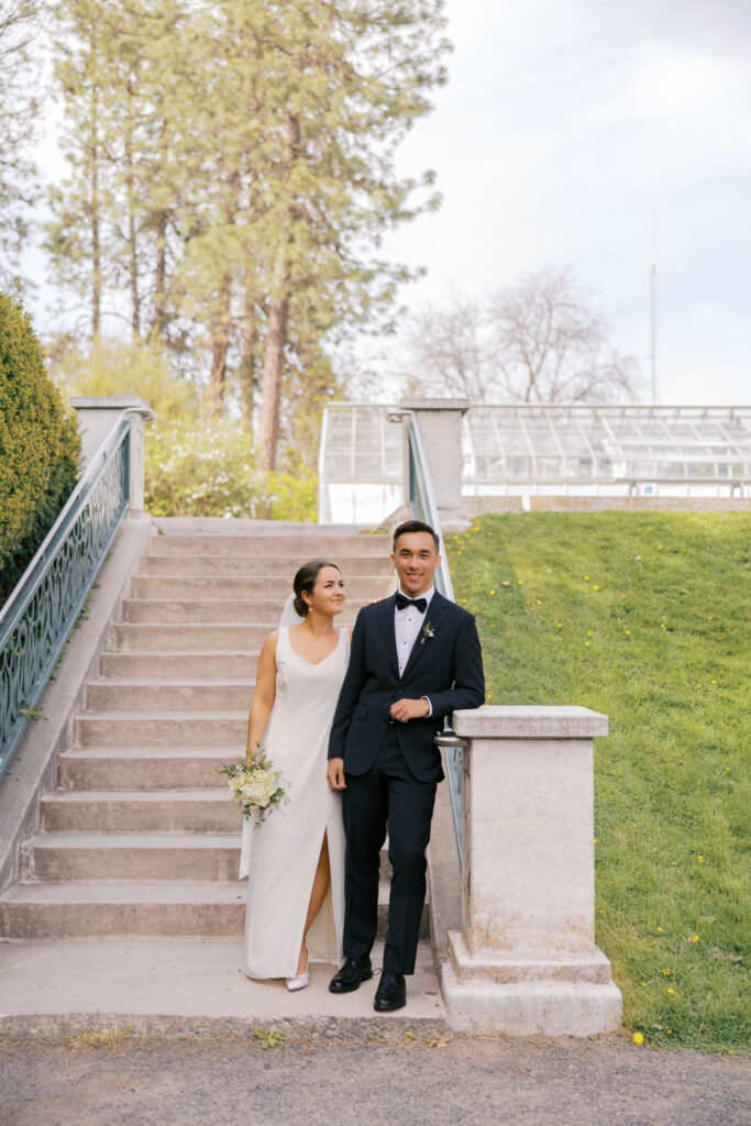 Bride looking at the groom at the bottom of the steps at Duncan Gardens in Manito Park in Spokane. 