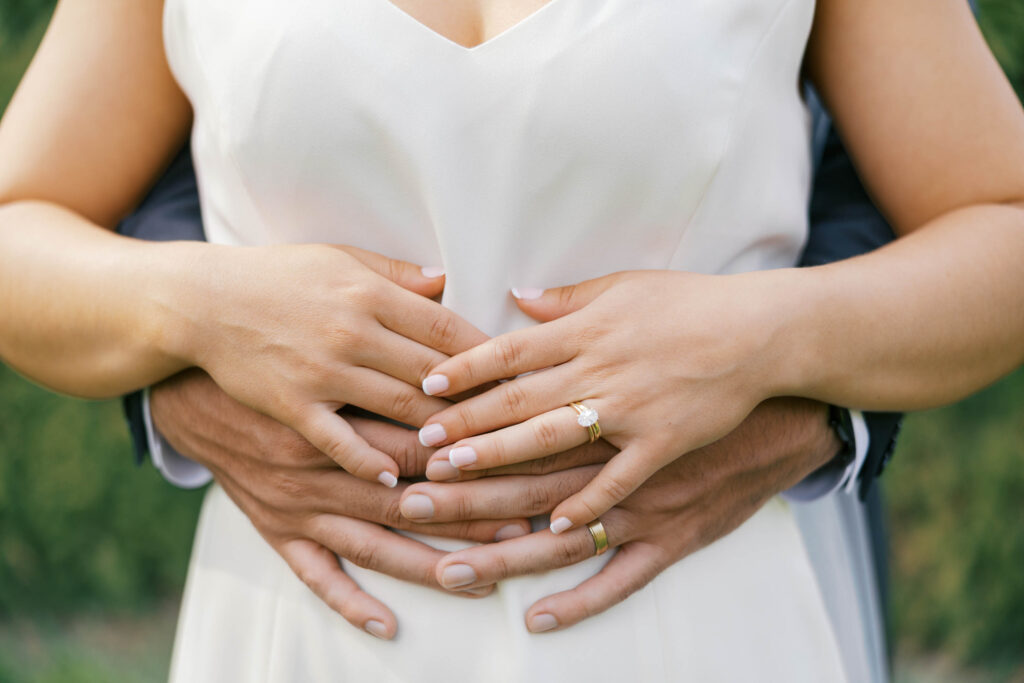 A bride and grooms hands with their rings after the wedding ceremony at overbluff cellars in spokane. 