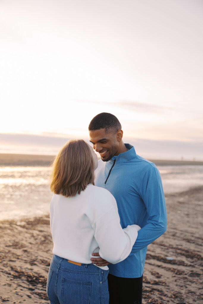 A'lon laughing with Julia during their engagement photos at Seabrook, Washington