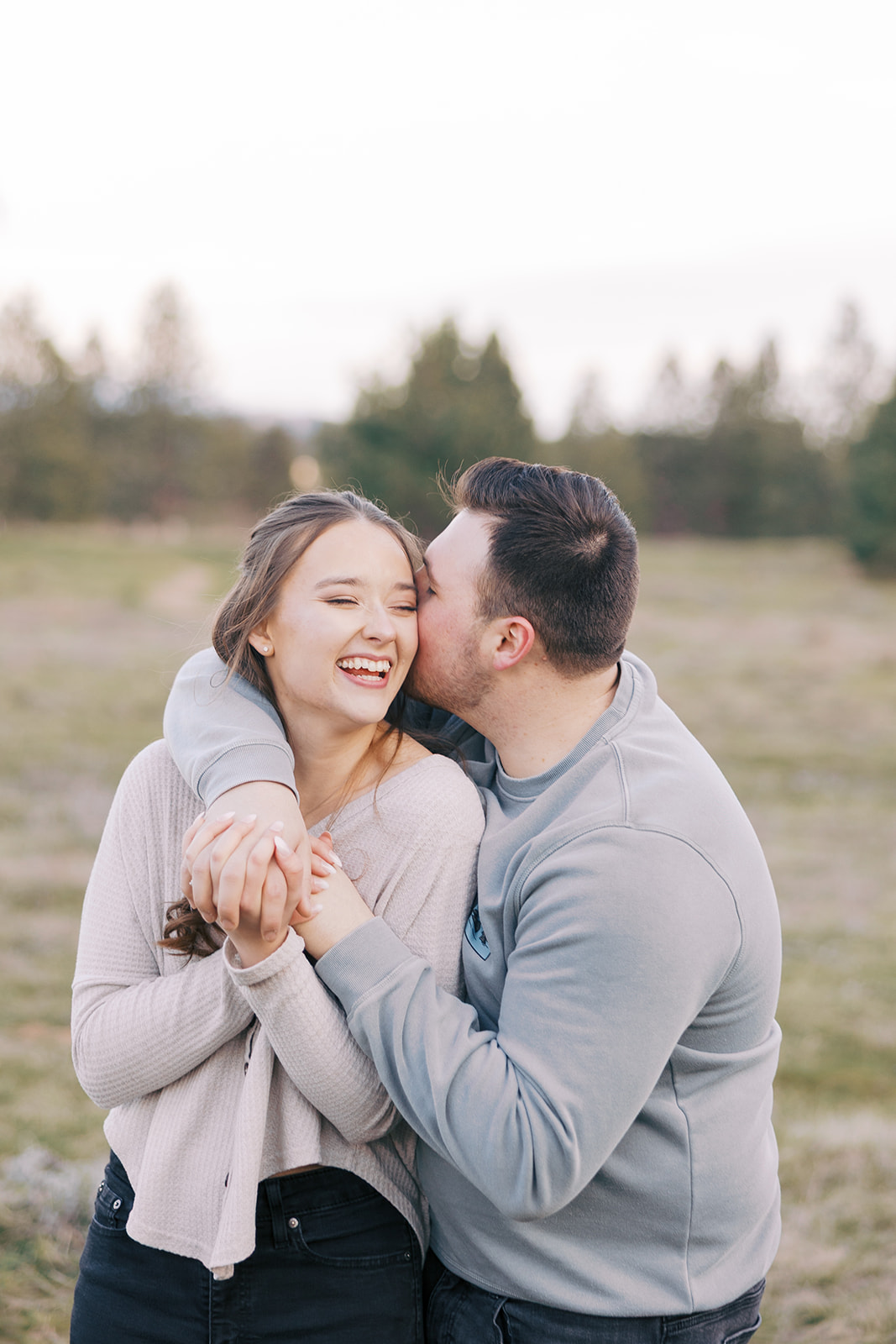 Couple laughing during engagement session in Spokane WA — natural and unposed wedding photography by Arch & Elm Photography